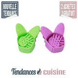 Passoire casserole Compactable auto fixante verte et violette démonstration de compactage gain de place - Tendances-cuisine.fr